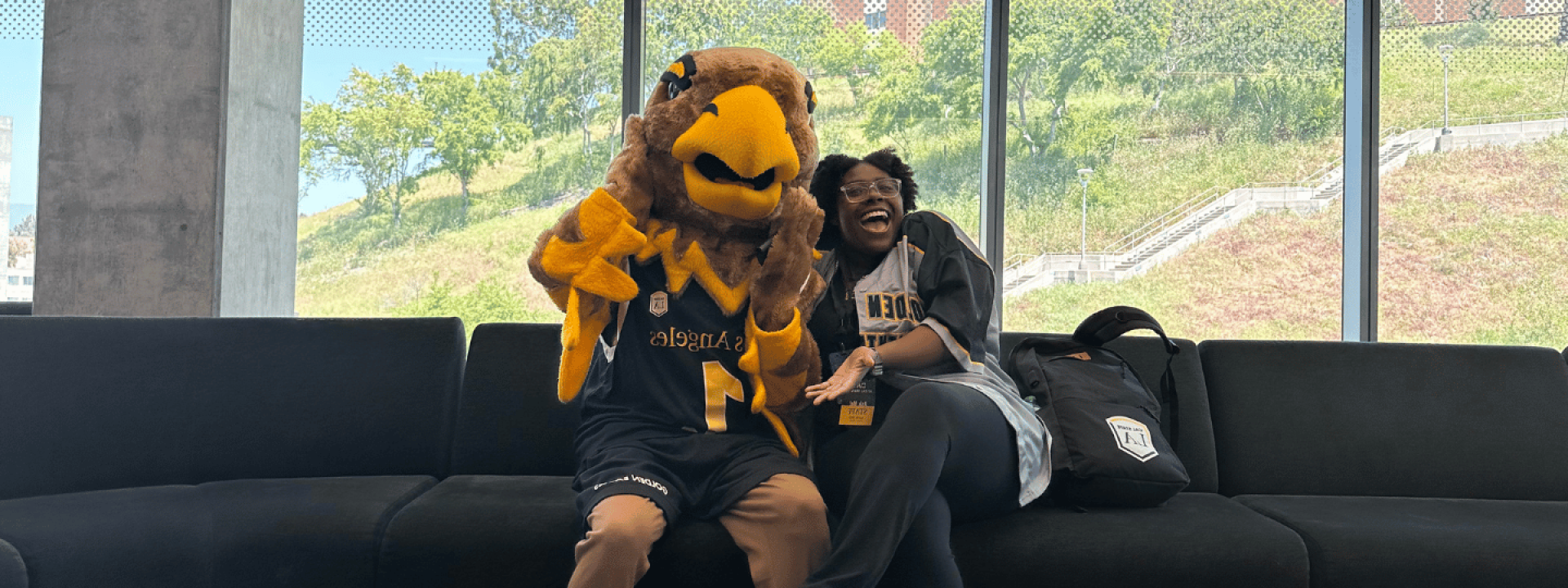 Eddie the Golden Eagle and a student in Housing.